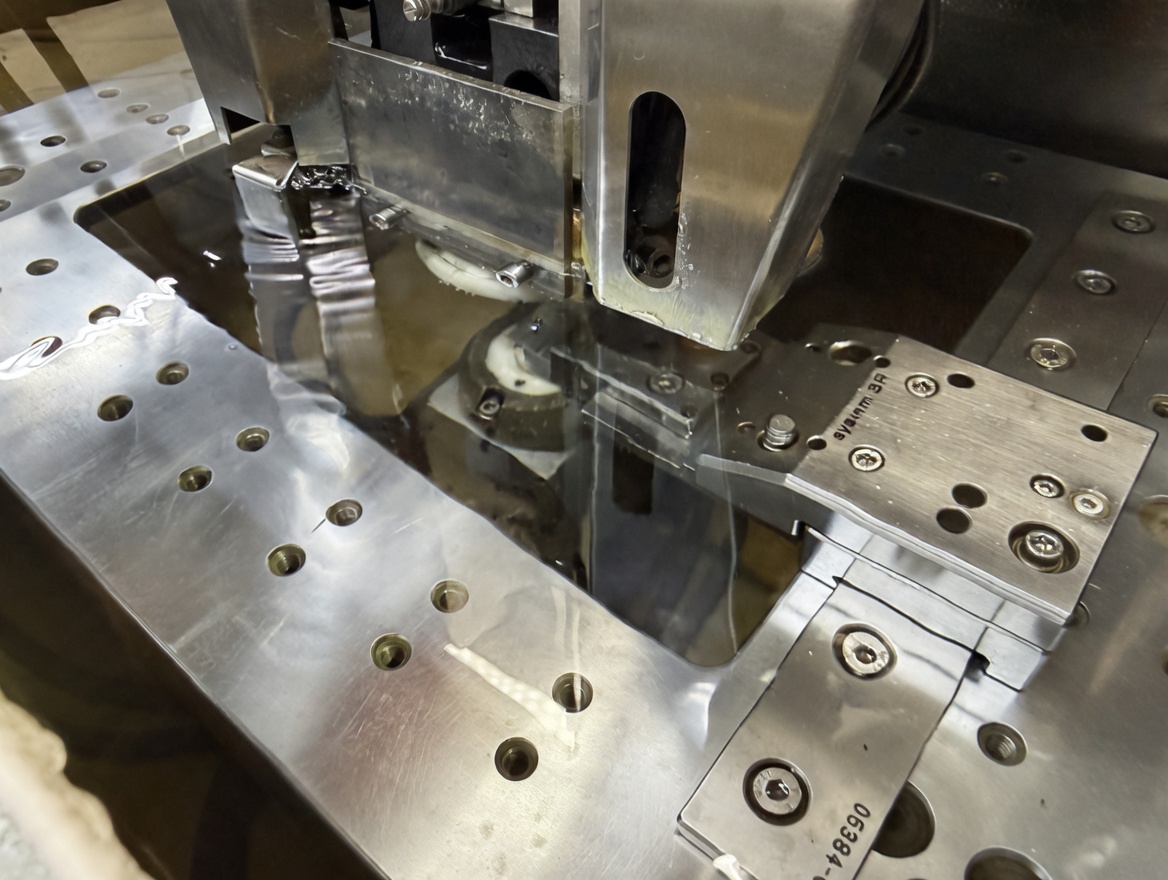 Wire EDM machine cutting hardened steel with sparks