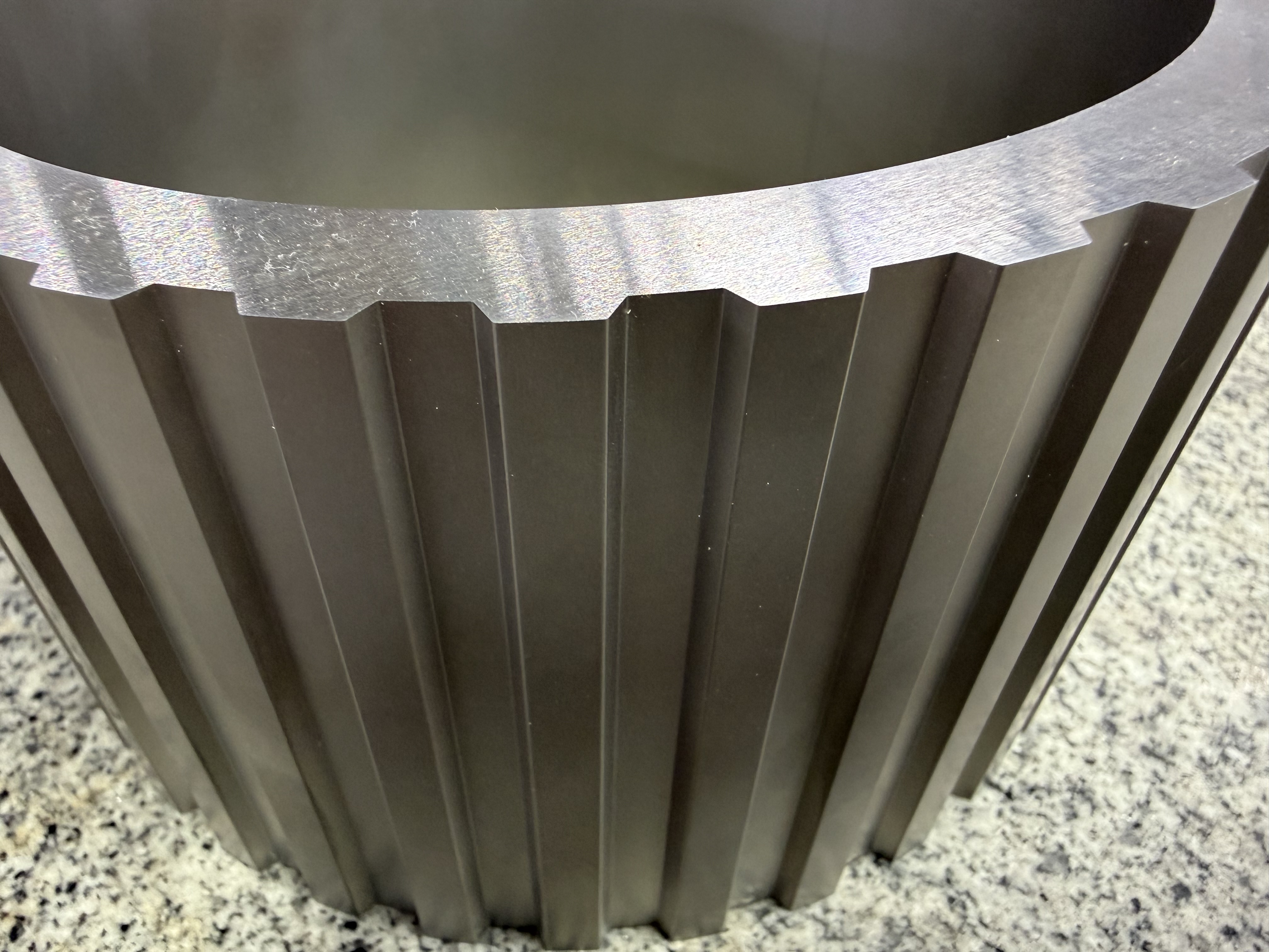 Close-up of brass wire electrode in dielectric fluid during EDM