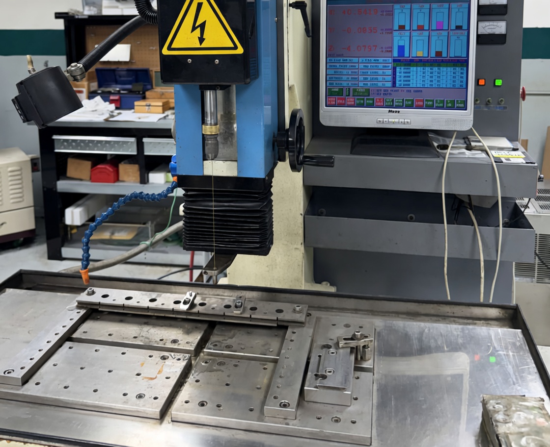 EDM hole drilling process producing small precision holes