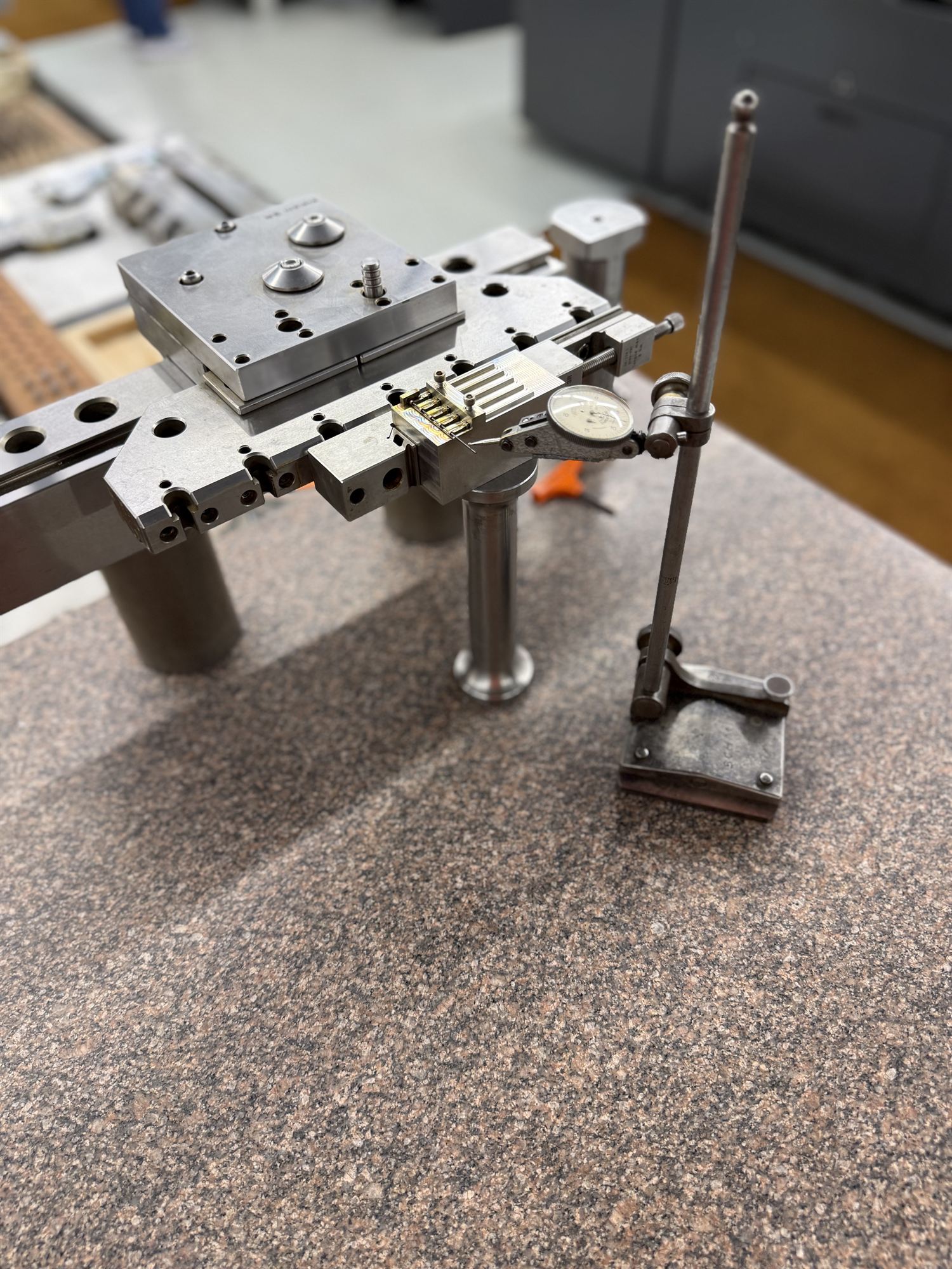 Indicator setup checking a small fixture on a surface plate