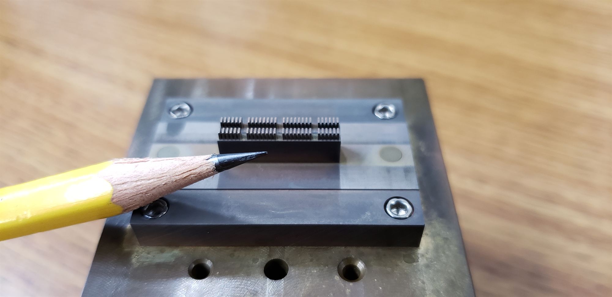 Micro-machined comb feature shown next to a pencil